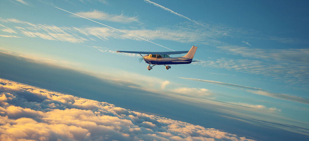 Cessna flying in the clouds at sunset